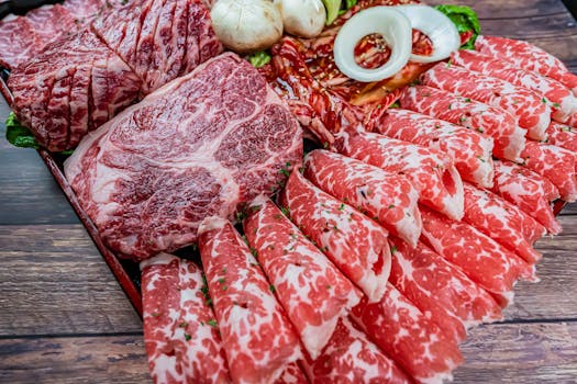 Close-up of marbled raw wagyu beef slices on a wooden tray, ideal for cooking.